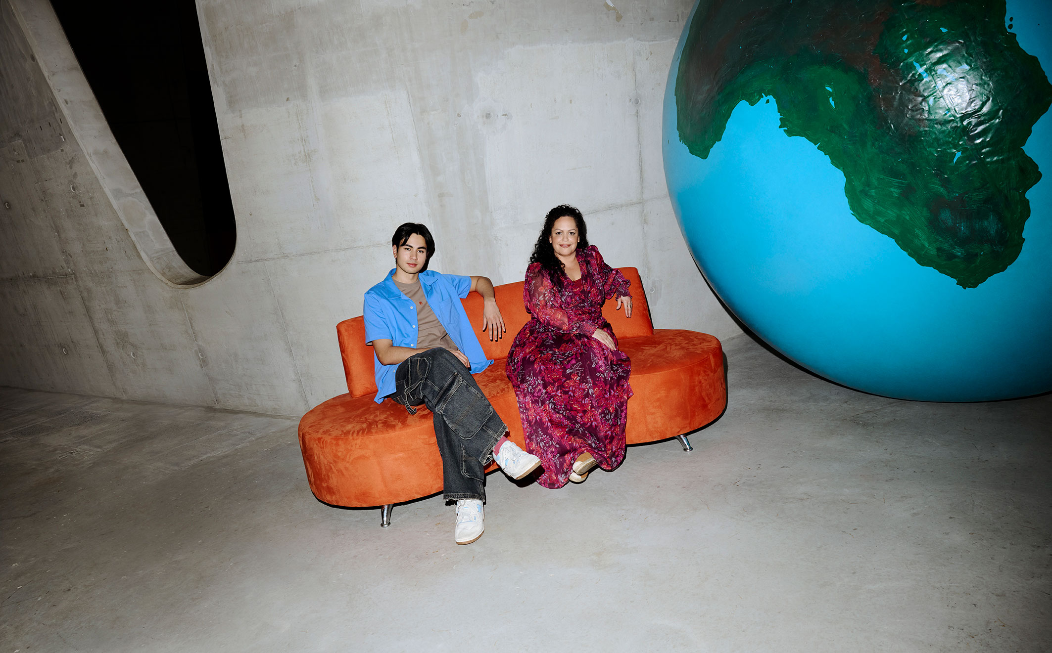 Staff and student sitting on lounge