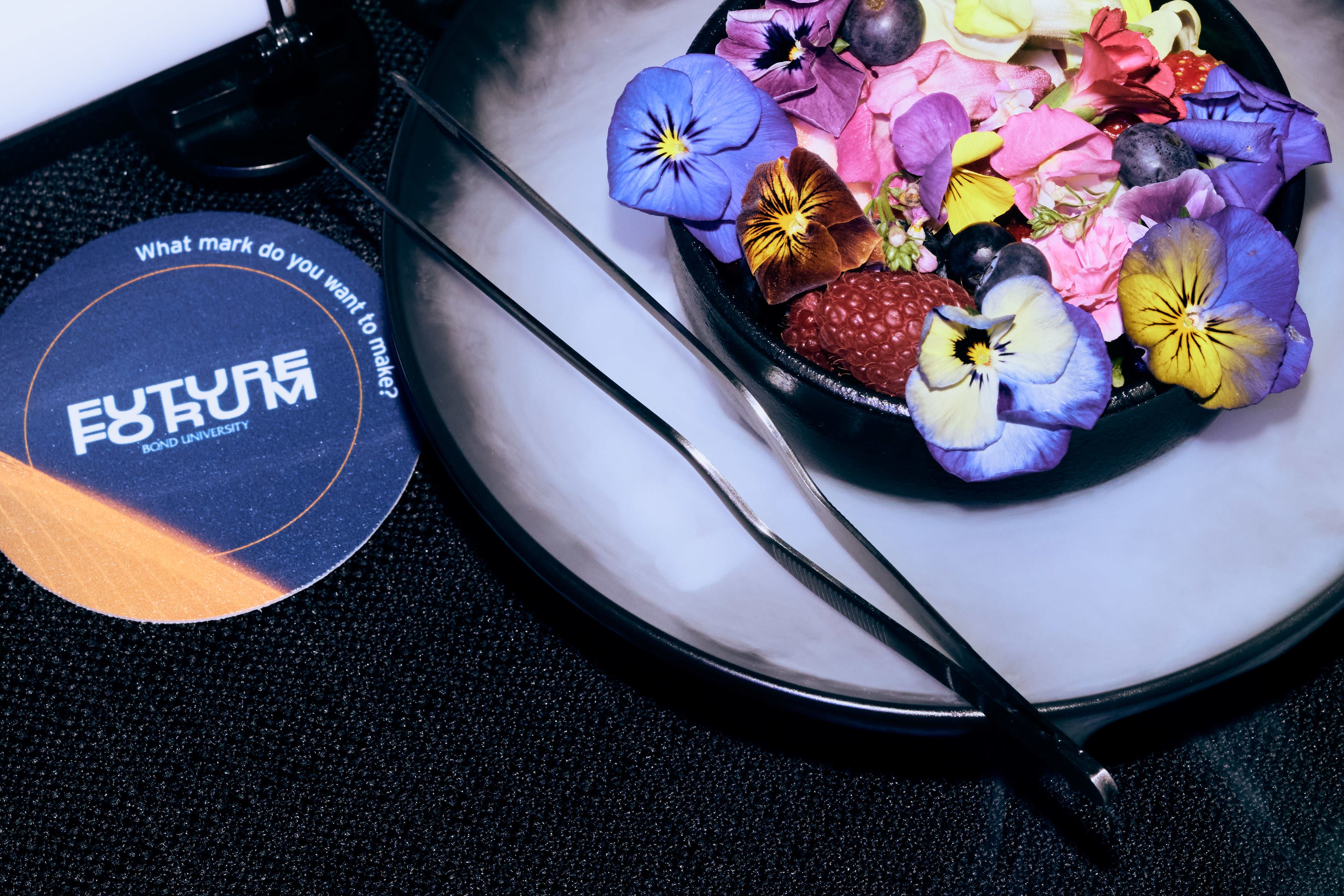 Fruit and flowers on a plate.