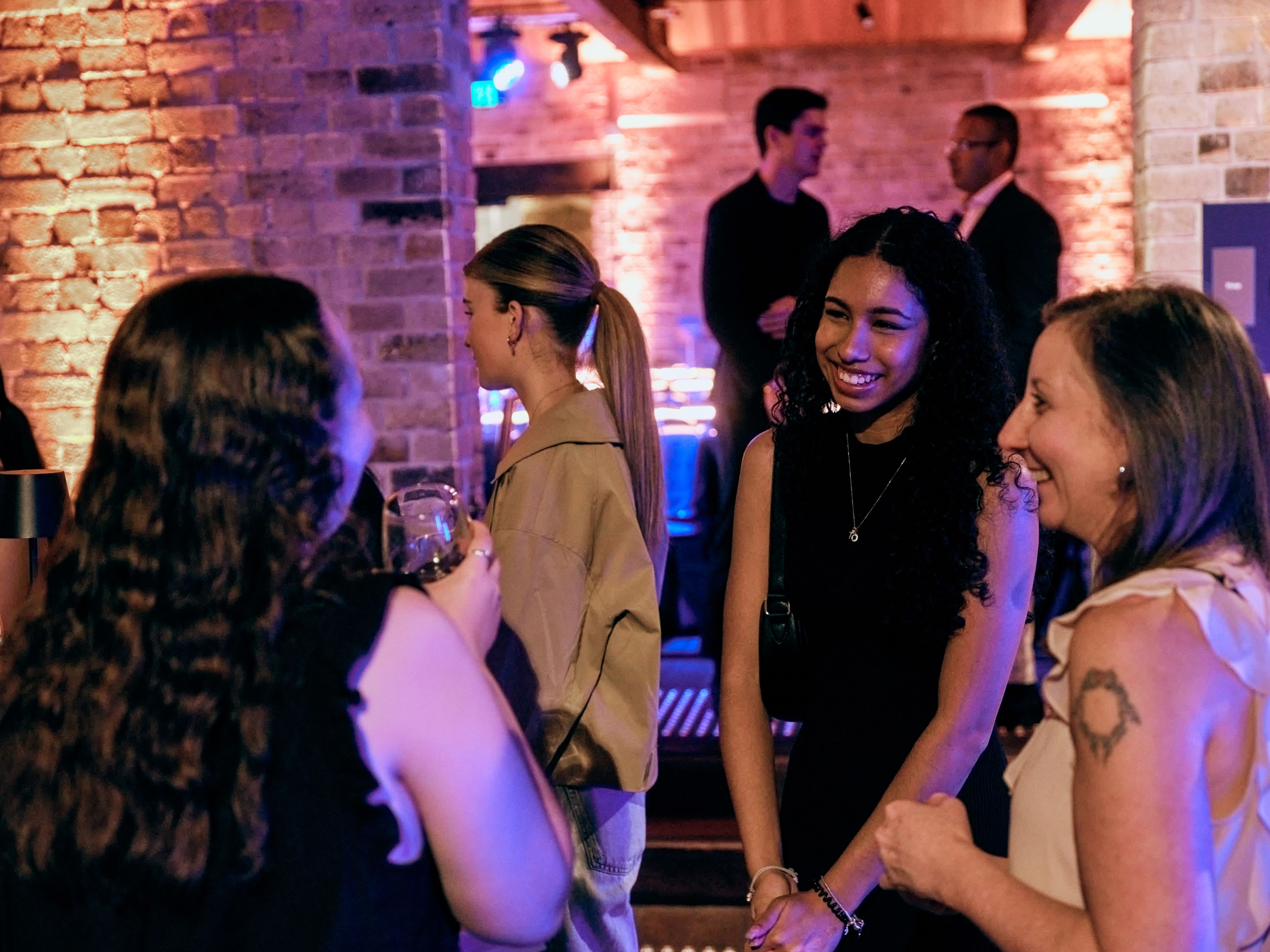 Three people are chatting and smiling. 