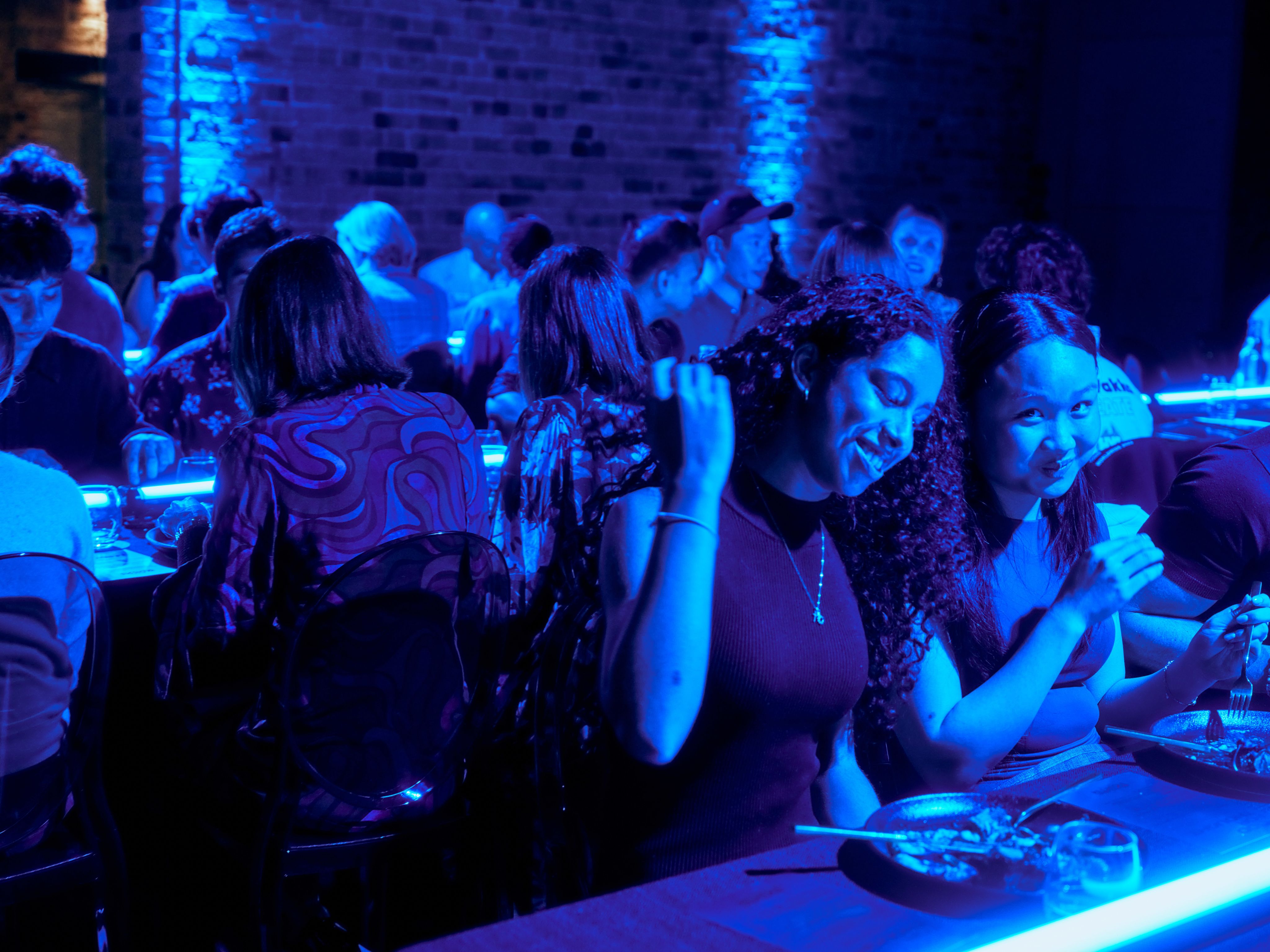 Two young women are sitting at a table.