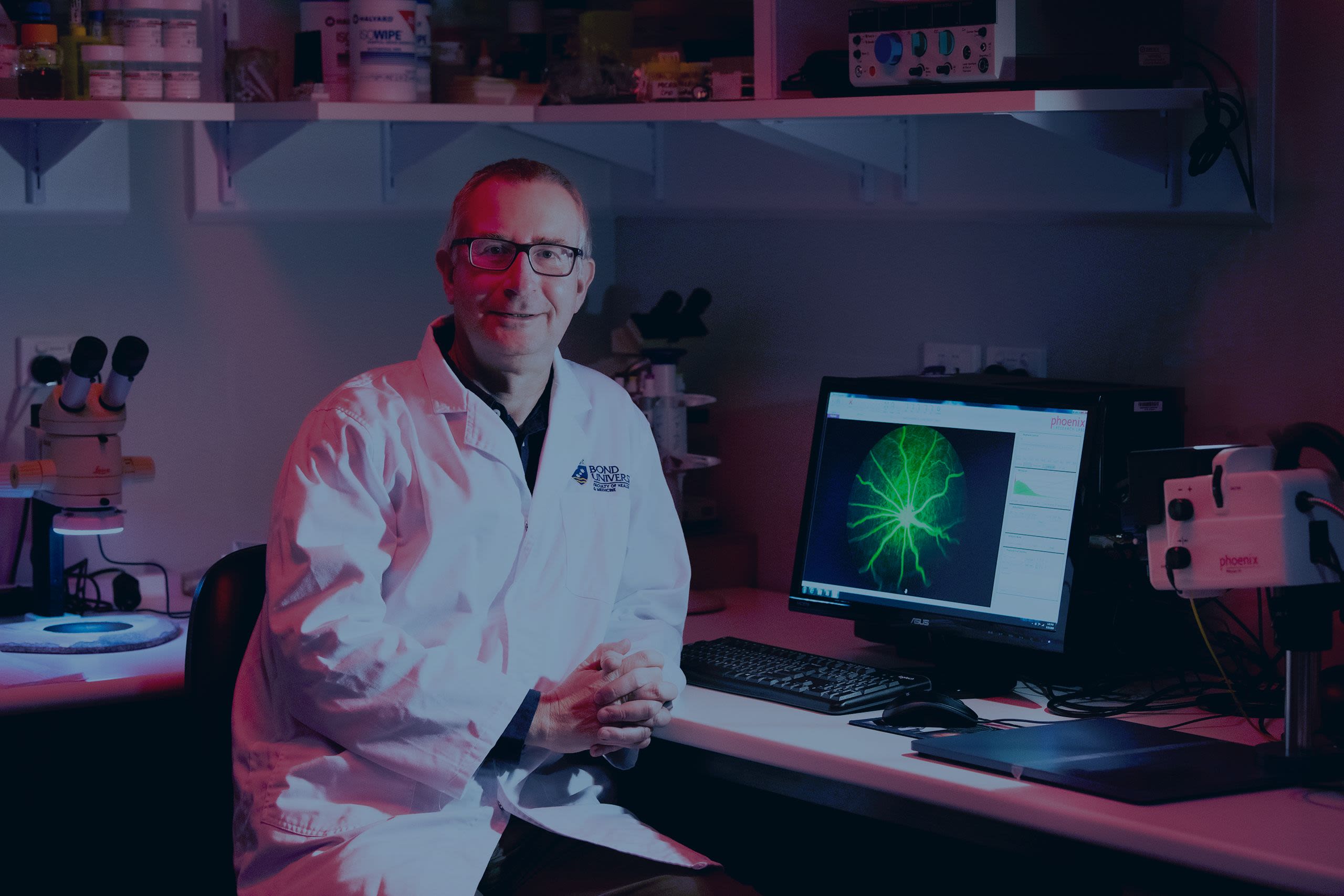 Nigel Barnett wears a labcoat in a laboratory