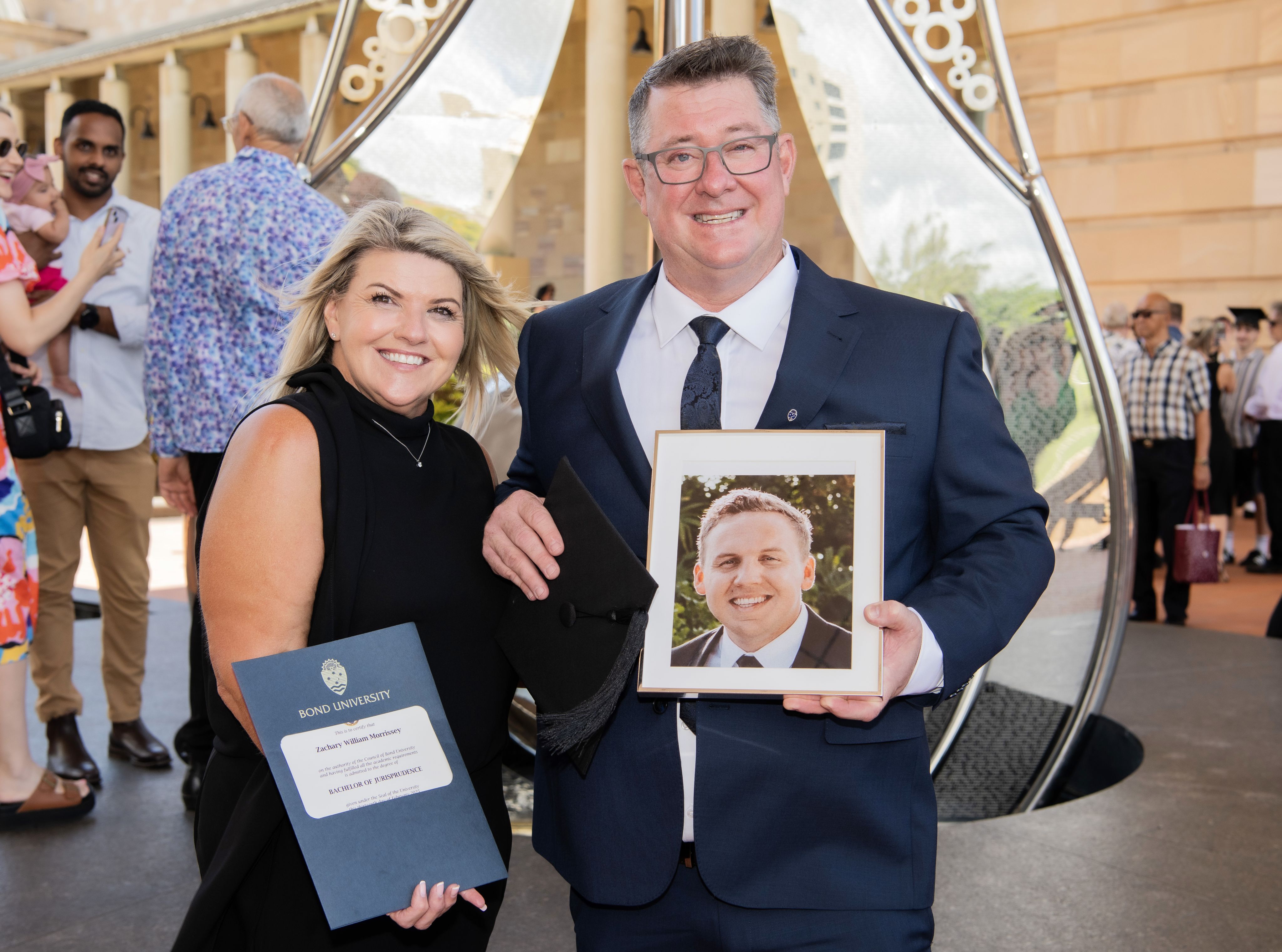 A couple holding a framed photo