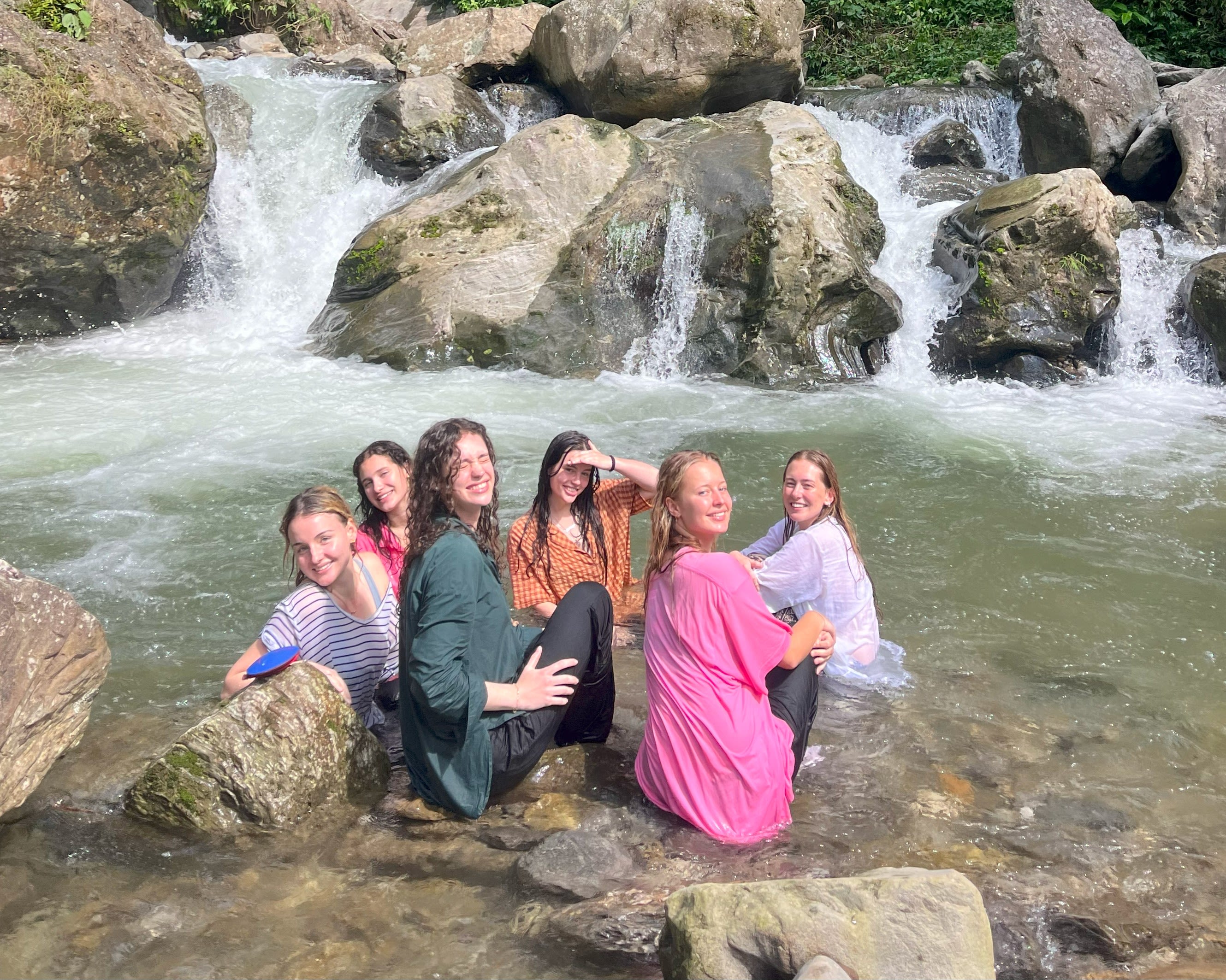 A group of young women in a waterfall
