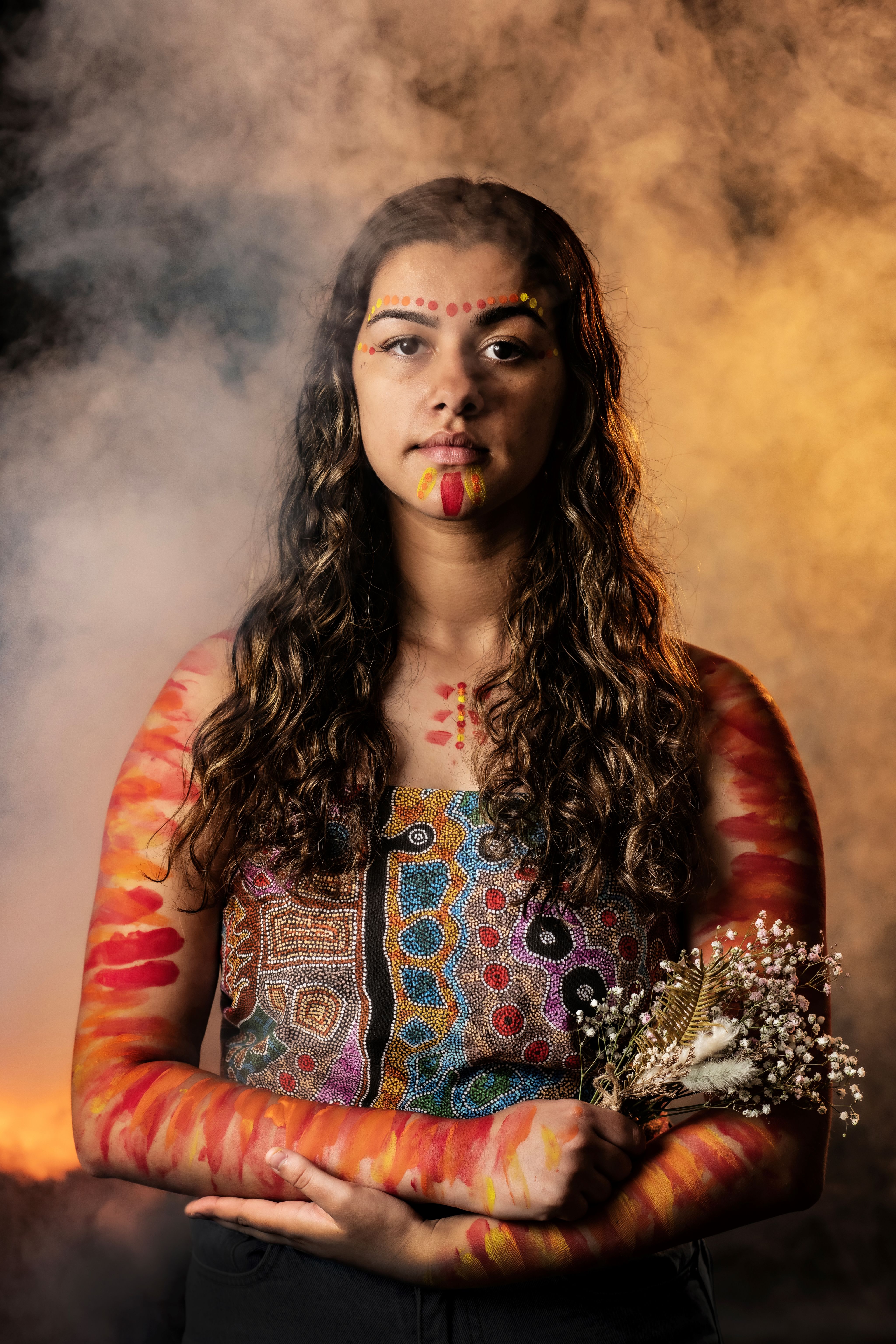 An Australian Indigenous woman wearing traditional body paint.
