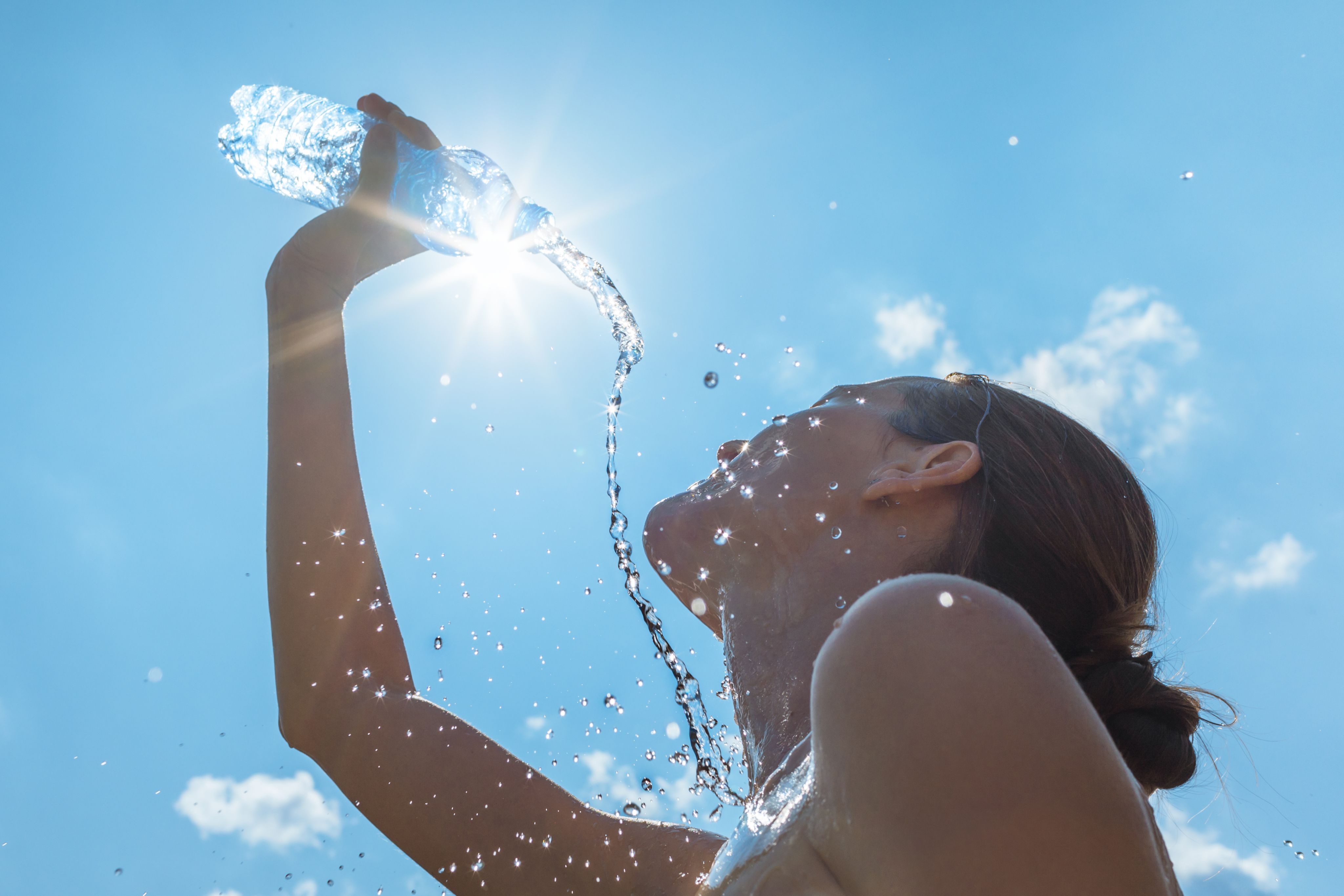 A woman is holding a water bottle