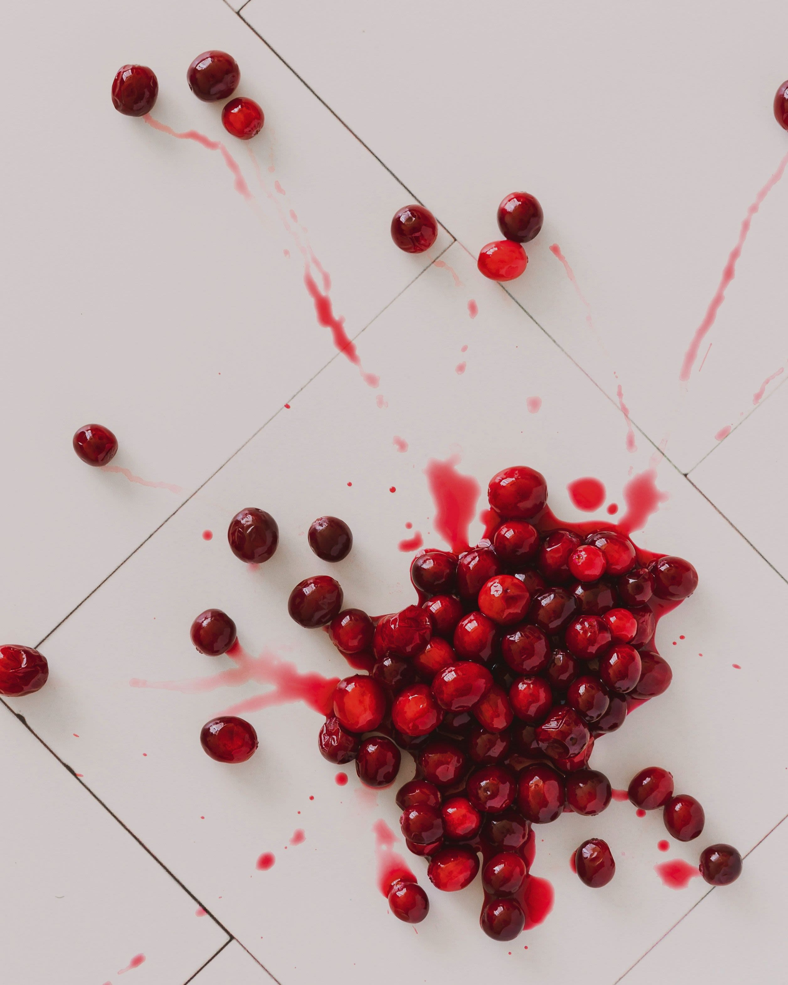 red round fruits on white surface