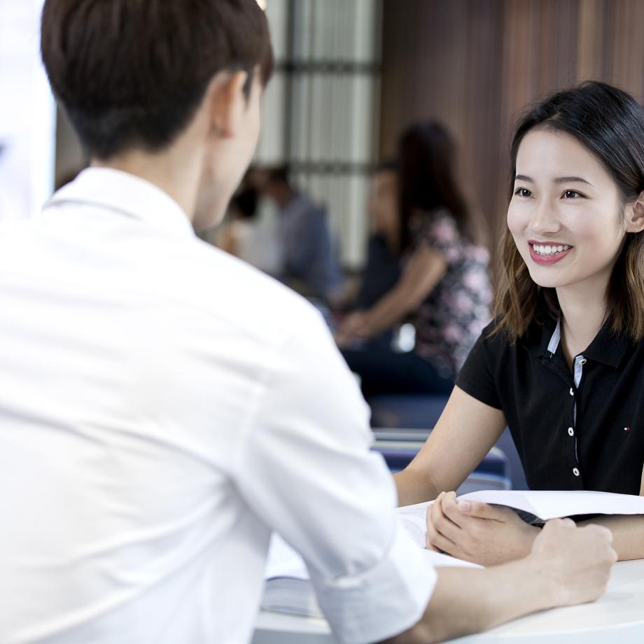 Two people in the Faculty of Law building.