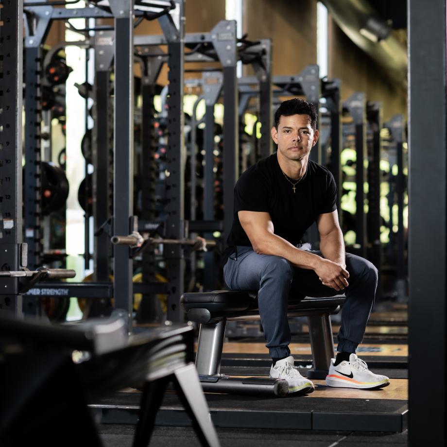 A man on a bench in a gym
