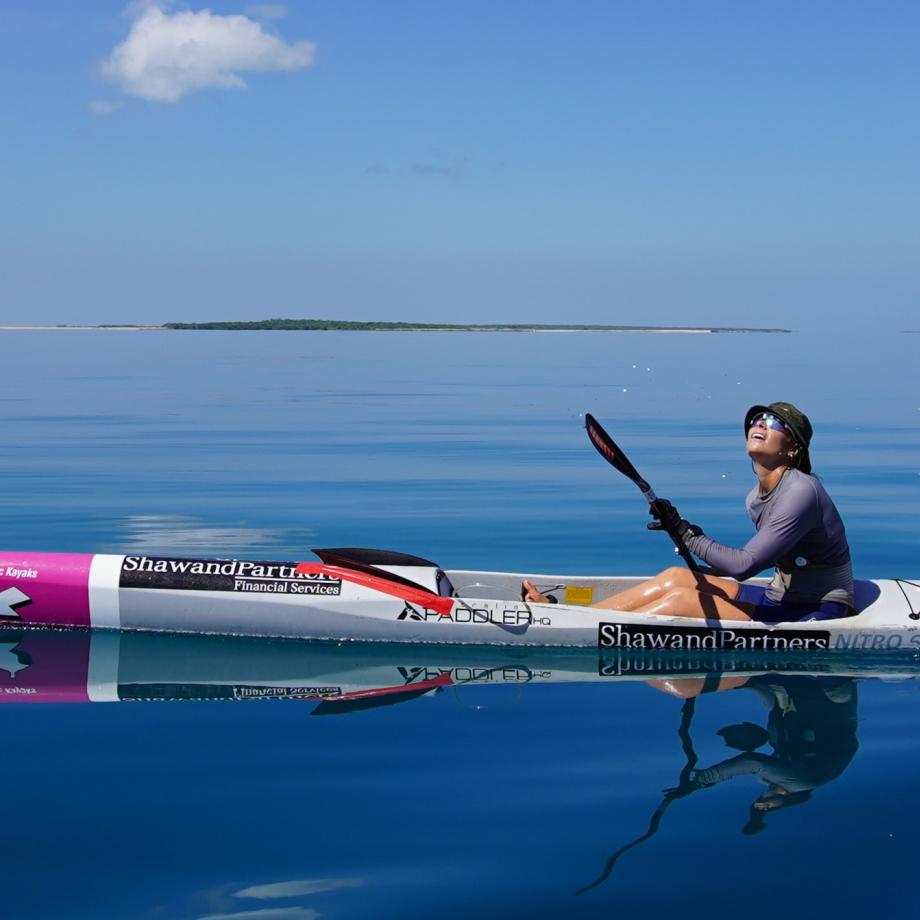 a woman on a surf ski in the ocean