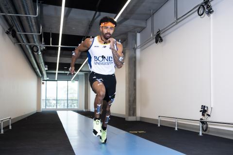 Athlete running down indoor track
