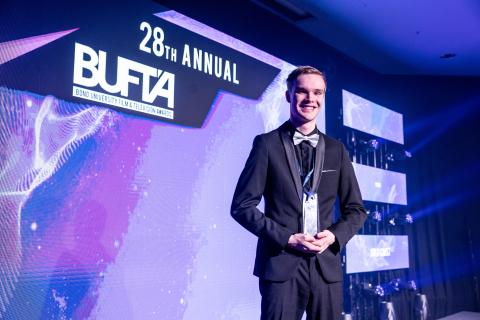 BUFTA Winner Benjamin Rosenberg on stage with his trophy.