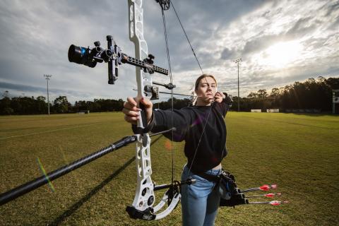 Amber Reinbott with her bow and arrows