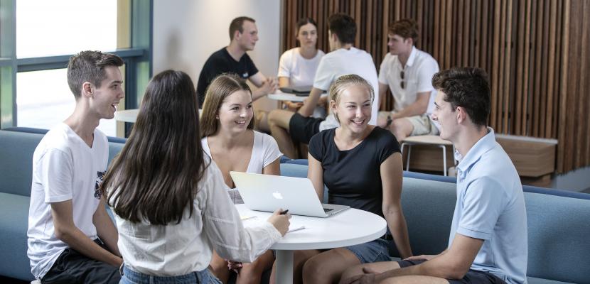 A group of people sitting down in a Bond University building.