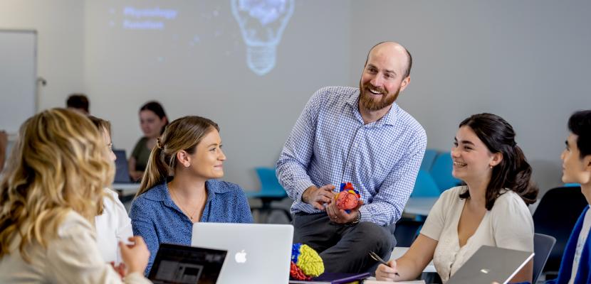 Charlotte Phelps, Christian Moro and others inside a Health Sciences & Medicine classroom.