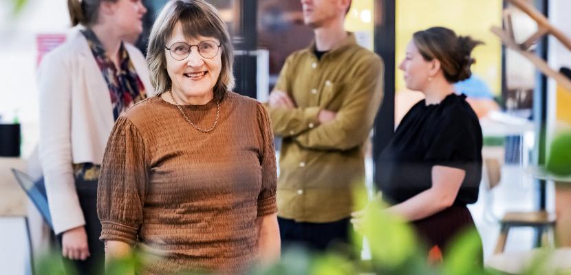 Professor Sharon Mickan smiling in front of a group of people