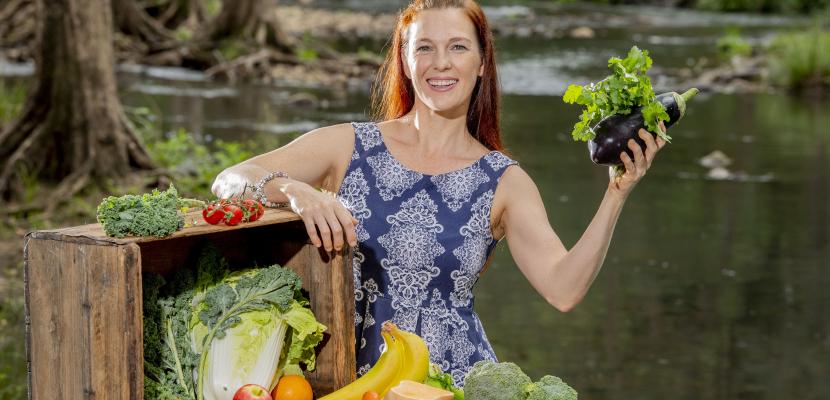 Dr Megan Lee holding fresh fruit and vegetables