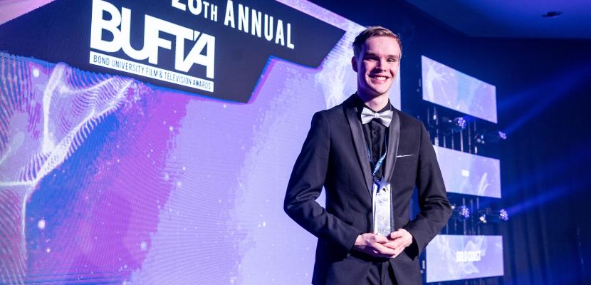 BUFTA Winner Benjamin Rosenberg on stage with his trophy.