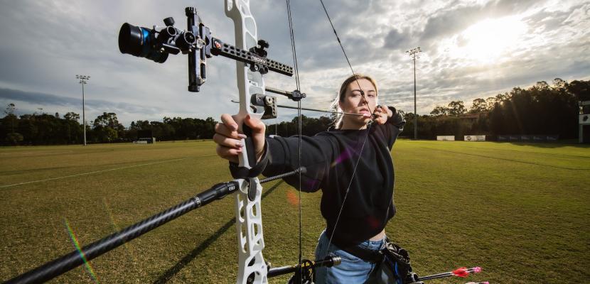 Amber Reinbott with her bow and arrows
