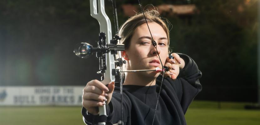 Amber Reinbott and her bow and arrow
