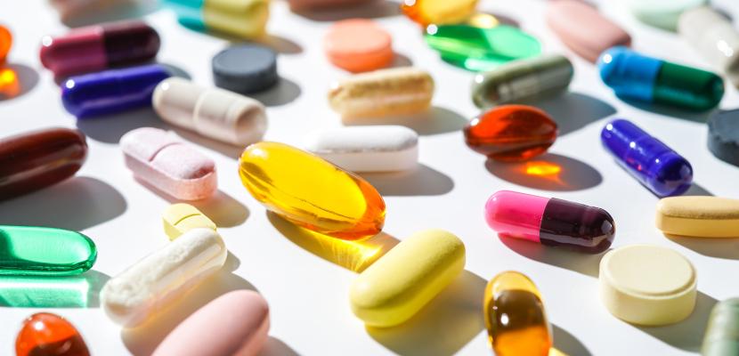 colourful medications scattered over a white surface