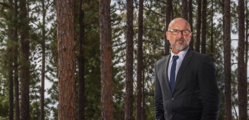 a man in front of trees