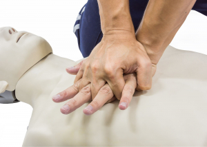 A person practices CPR on a dummy 